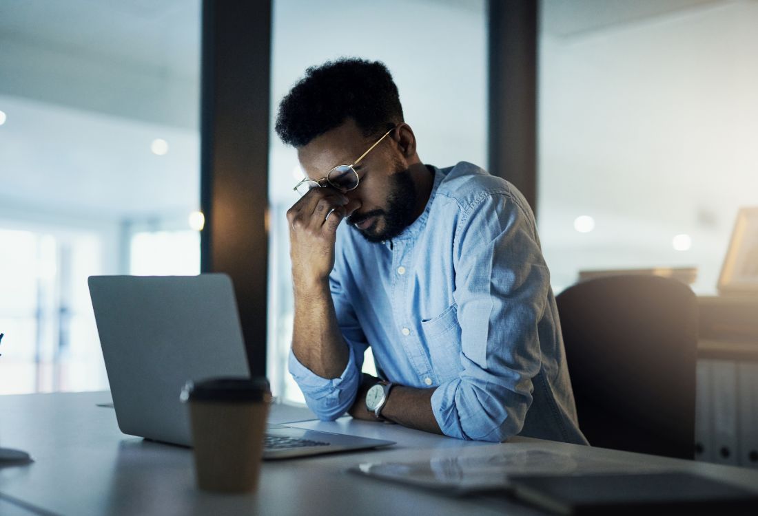 A business owner being stressed from having app development problems from choosing a cut-price developer.