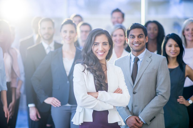 A Car Dealership team smiling as they see the benefits of developing an app.