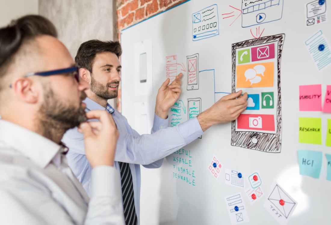 Employees of an app development company working thinking about how to develop their new app project.